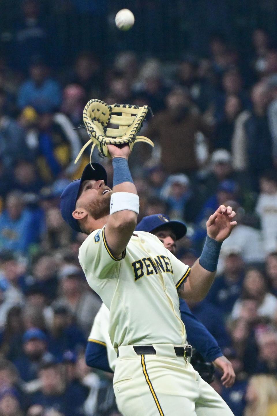 Apr 2, 2024; Milwaukee, Wisconsin, USA; Milwaukee Brewers first baseman Jake Bauers (9) catches a popup hit by Minnesota Twins catcher Christian Vazquez (not pictured) in the third inning at American Family Field. Mandatory Credit: Benny Sieu-USA TODAY Sports