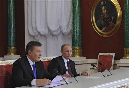 Ukrainian President Viktor Yanukovich (L) makes a statement as his Russian counterpart Vladimir Putin listens at a meeting of the Russian-Ukrainian Interstate Commission at the Kremlin in Moscow, December 17, 2013. REUTERS/Michael Klimentyev/RIA Novosti/Kremlin