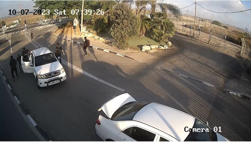 Hamas militants arrive in a vehicle at Yakhini, an orthodox moshav near Sderot in the northern Negev Desert