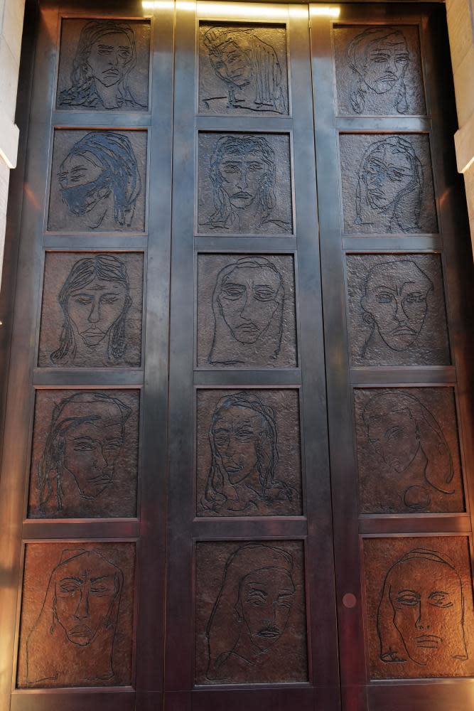 Bronze door with Tracey Emin portraits