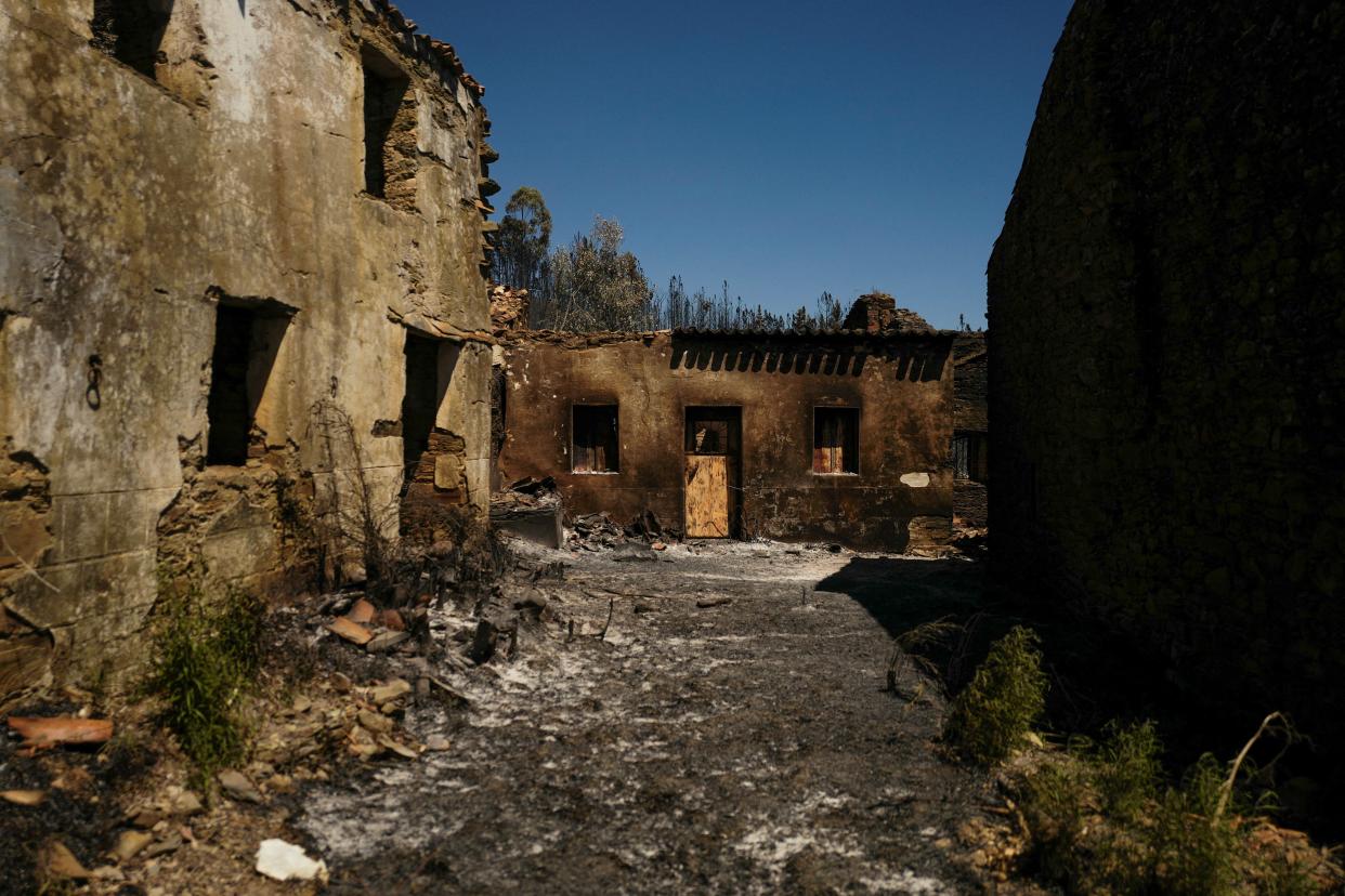 A view of burned buildings from a wildfire in Proenca-a-Nova, Portugal, 6 August (REUTERS)