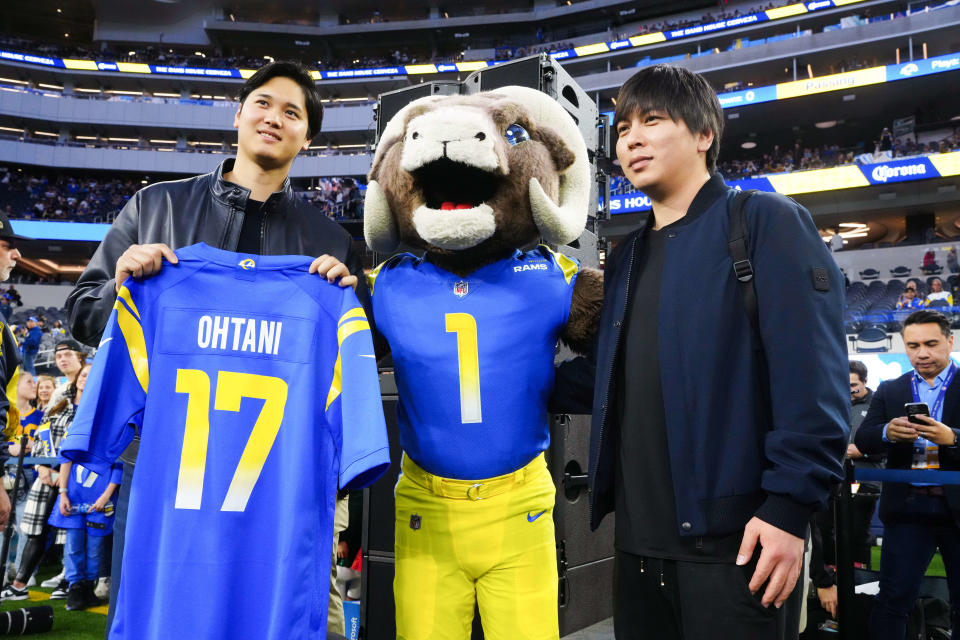 The Los Angeles Dodgers' Shohei Ohtani (left) and interpreter Ippei Mizuhara (right) pose with Los Angeles Rams mascot Rampage at SoFi Stadium.