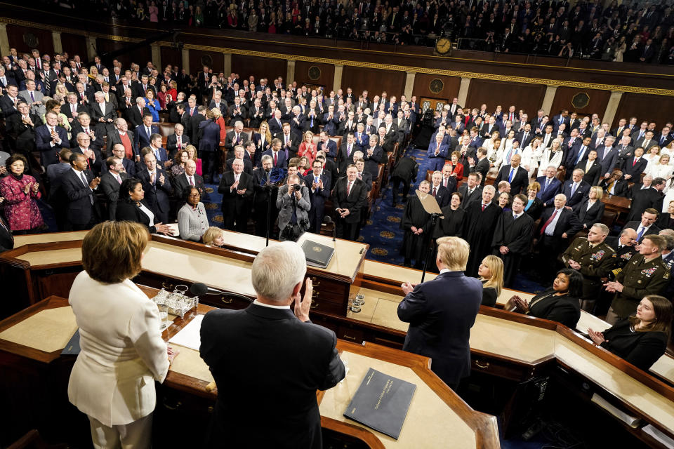 President Donald Trump arrives to delivers his State of the Union address to a joint session of Congress on Capitol Hill in Washington, Tuesday, Feb. 4, 2020, as House Speaker Nancy Pelosi of Calif., left, and Vice President Mike Pence watch. (Doug Mills/The New York Times via AP, Pool)