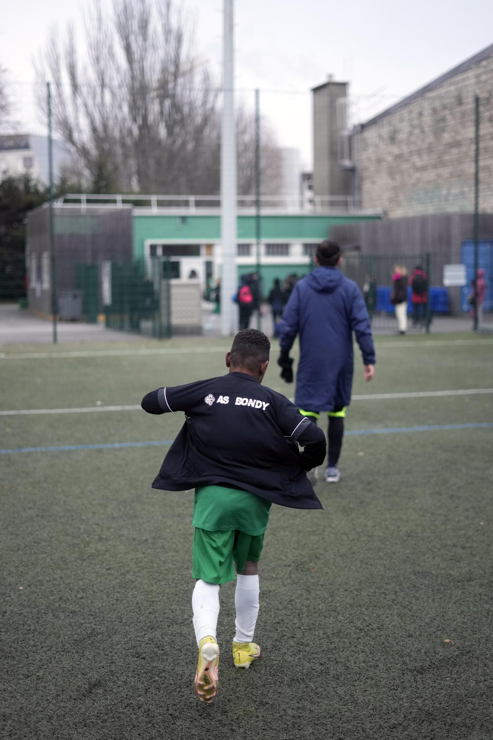 A player of the football club AS Bondy, where Kylian Mbappe played as a kid, leaves the pitch after a match on the Leo Lagrange stadium in Bondy, east of Paris, Saturday, Dec. 17, 2022. On the football fields where Kylian Mbappe hones the feints, dribbles and shots that all of France hopes to see in Sunday's World Cup final against Argentine, the next generation of French kids with big dreams is already hard at work to follow in the superstar's footsteps. (AP Photo/Thibault Camus)