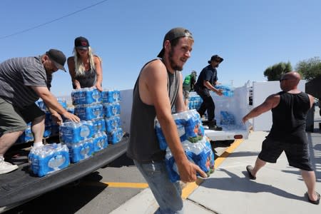 Community Emergency Response Team (CERT) disaster response volunteers deliver water to the community after a powerful magnitude 7.1 earthquake broke, triggered by a 6.4 the previous day, near the epicenter in Trona, California,