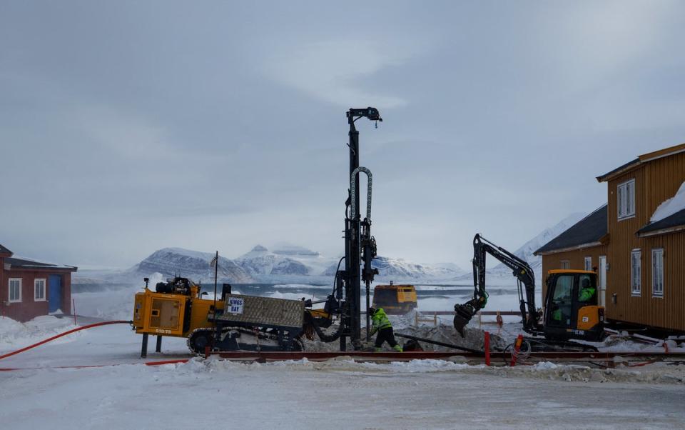 Workers repair the town store after it was damaged by thawing permafrost (Reuters)