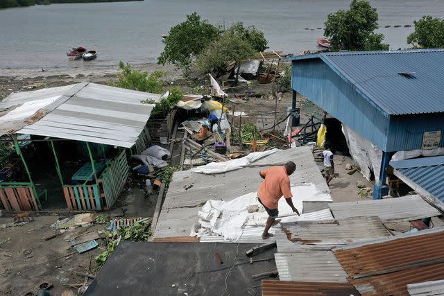 <p>Joe Raedle/Getty</p> The aftermath of Hurricane Beryl in Old Harbor, Jamaica