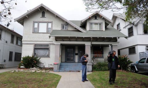 Journalists are seen in front of the house where a Chinese student ran for help after he and a fellow student were shot in Los Angeles on April 11, 2012 in California. The two Chinese graduate students from the University of Southern California (USC) were killed in a shooting, police suspect could have been a failed carjacking