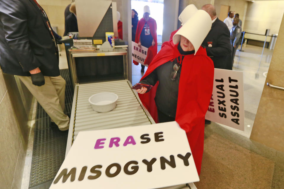 Equal Rights Amendment supporters make their way through security as they arrive for for the 2020 session outside Virginia state Capitol in Richmond, Va., Wednesday, Jan. 8, 2020. (AP Photo/Steve Helber)