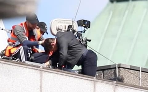 Tom Cruise injures his leg while jumping from building to building as he films a stunt for Mission Impossible 6 in Central London - Credit: MEGA