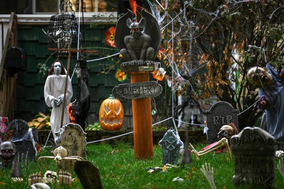 An elaborate graveyard scene set up in the yard of a home on the 1000 block of Parker Street photographed on Monday, Oct. 17, 2022, in Lansing.