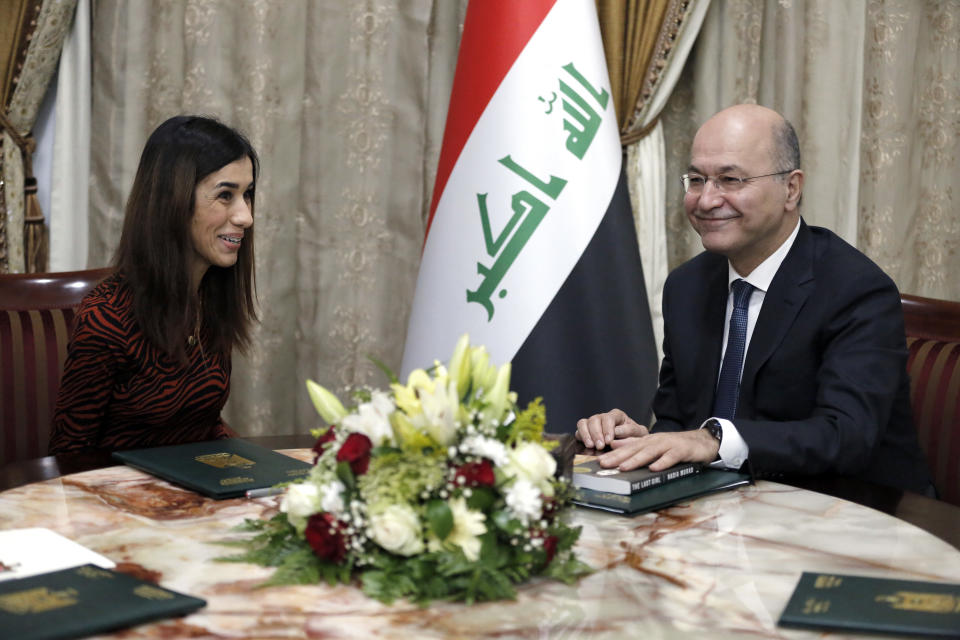 Nobel Peace Prize recipient Nadia Murad, left, meets with her country's President Barham Salih, in Baghdad, Iraq, Wednesday, Dec. 12, 2018. Murad received the prize in 2018 for her advocacy on behalf of victims of wartime sexual violence. Murad, a member of Iraq's Yazidi minority, was among thousands of women and girls who were captured and forced into sexual slavery by Islamic State militants in 2014. (AP Photo/Karim Kadim)