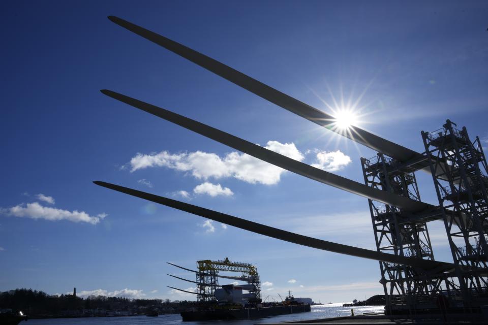 A generator and its blades, bottom, are tugged at sea leaving State Pier in New London, Conn., Monday, Dec. 4, 2023, heading to South Fork Wind farm. (AP Photo/Seth Wenig)