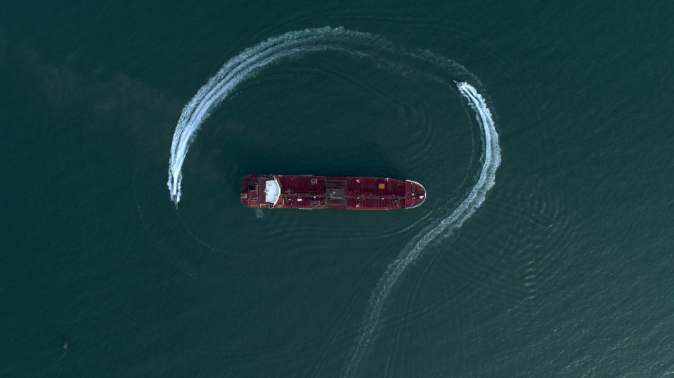 Speedboats from Iran's Revolutionary Guard circle the British-flagged oil tanker Stena Impero on Sunday, July 21, 2019 in the Iranian port of Bandar Abbas, after it was seized in the Strait of Hormuz two days earlier. Iran's president, Hassan Rouhani, suggested Wednesday that Stena Impero could be released if the U.K. takes similar steps to hand back an Iranian oil tanker seized by the Royal Navy off Gibraltar earlier this month. (Morteza Akhoondi/Tasnim News Agency via AP)