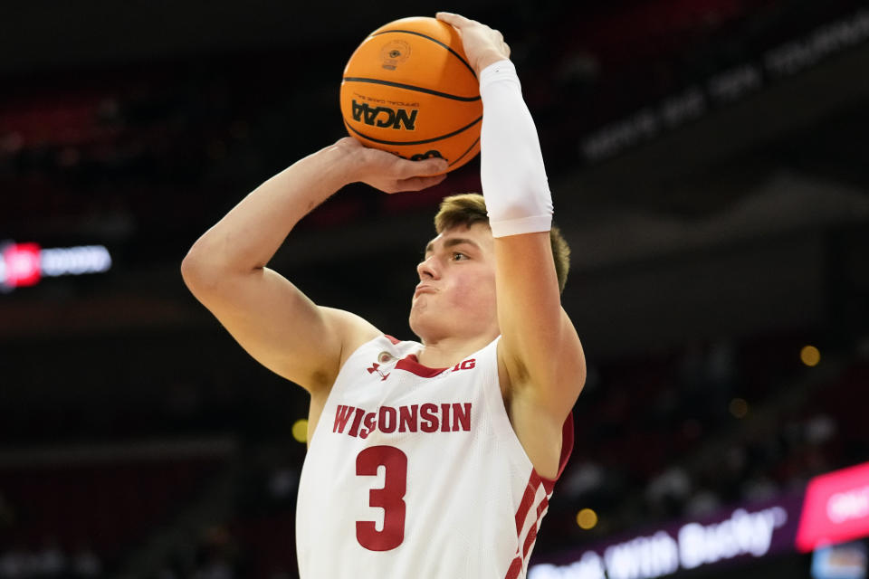 Feb 22, 2023; Madison, Wisconsin, USA; Wisconsin Badgers guard Connor Essegian (3) scores a three-point shot during the second half against the Iowa Hawkeyes at the Kohl Center. Mandatory Credit: Kayla Wolf-USA TODAY Sports