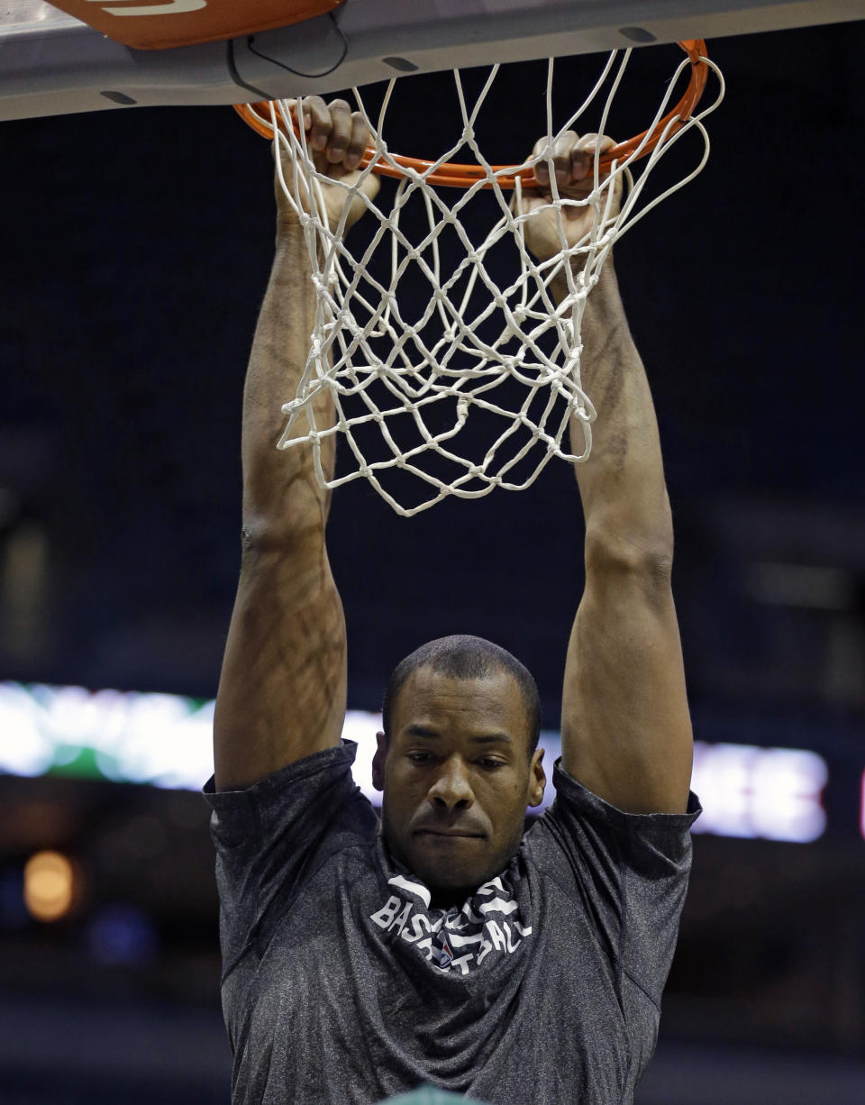 Brooklyn Nets' Jason Collins dunks before an NBA basketball game against the Milwaukee Bucks Saturday, March 1, 2014, in Milwaukee. (AP Photo/Jeffrey Phelps)