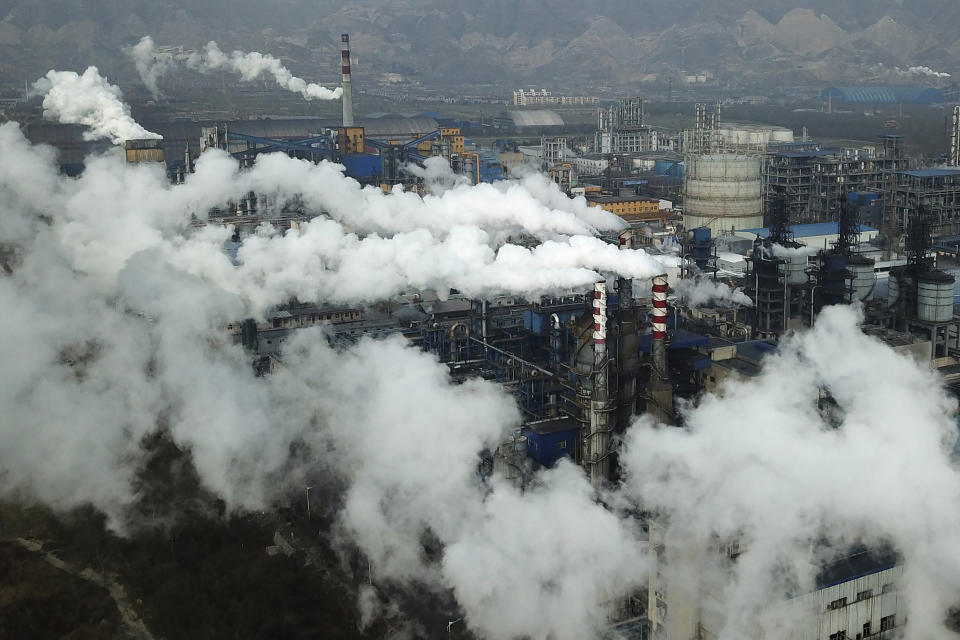FILE - In this Nov. 28, 2019, file photo, smoke and steam rise from a coal processing plant in Hejin in central China's Shanxi Province. Chinese power companies bid for credits to emit carbon dioxide and other climate-changing gases as trading on the first national carbon exchange began Friday, July 16, 2021 in a step meant to help curb worsening pollution. (AP Photo/Sam McNeil, File)