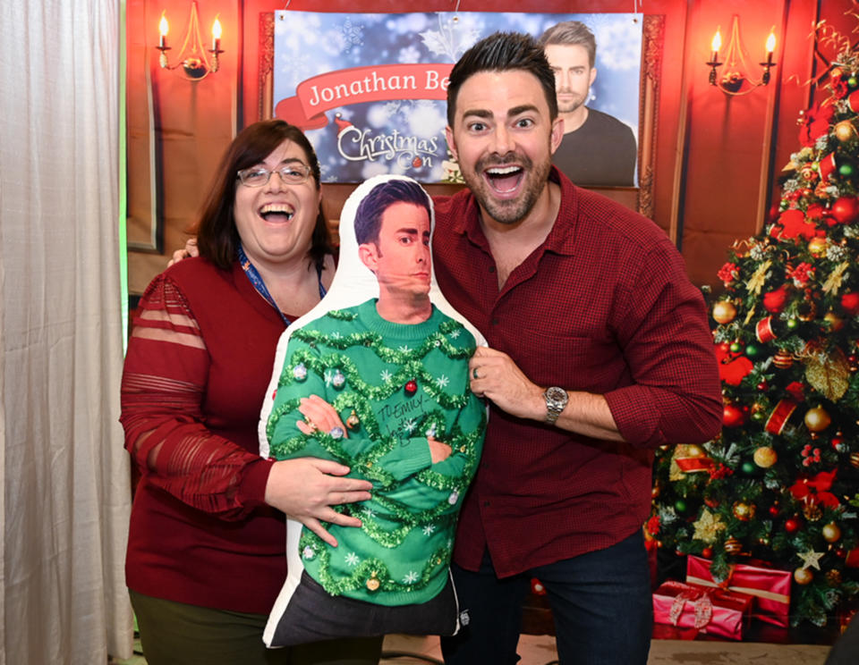 <p>Jonathan Bennett poses with a fan and a pillow featuring his likeness during Hallmark's third annual ChristmasCon in Edison, New Jersey, on Dec. 12. </p>