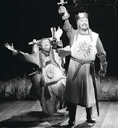 Patsy (Michael McGrath) kneels behind King Arthur (Tim Curry) in a production photo from the new musical "Monty Python\'s Spamalot," which opens March 17 at New York\'s Shubert Theatre. AP photo