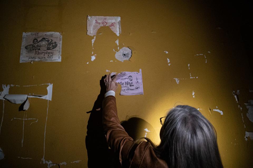 Cheryl Votzmeyer-Rios, Corpus Christi PATCH executive director, looks at old show posters hanging on the costume room walls of the historic Ritz Theatre on Wednesday, Feb. 1, 2023, in Corpus Christi, Texas. 