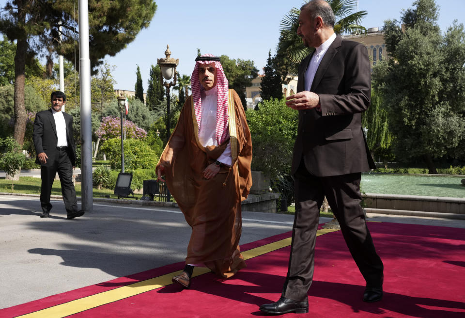 Saudi Arabia's Foreign Minister Prince Faisal bin Farhan, left, is welcomed by his Iranian counterpart Hossein Amirabdollahian prior to their meeting in Tehran, Iran, Saturday, June 17, 2023. Saudi Arabia’s top diplomat has arrived in the Iranian capital,Tehran, the latest step in the restoration of diplomatic ties between the two Mideast rivals, Iranian state media reported. (AP Photo/Vahid Salemi)