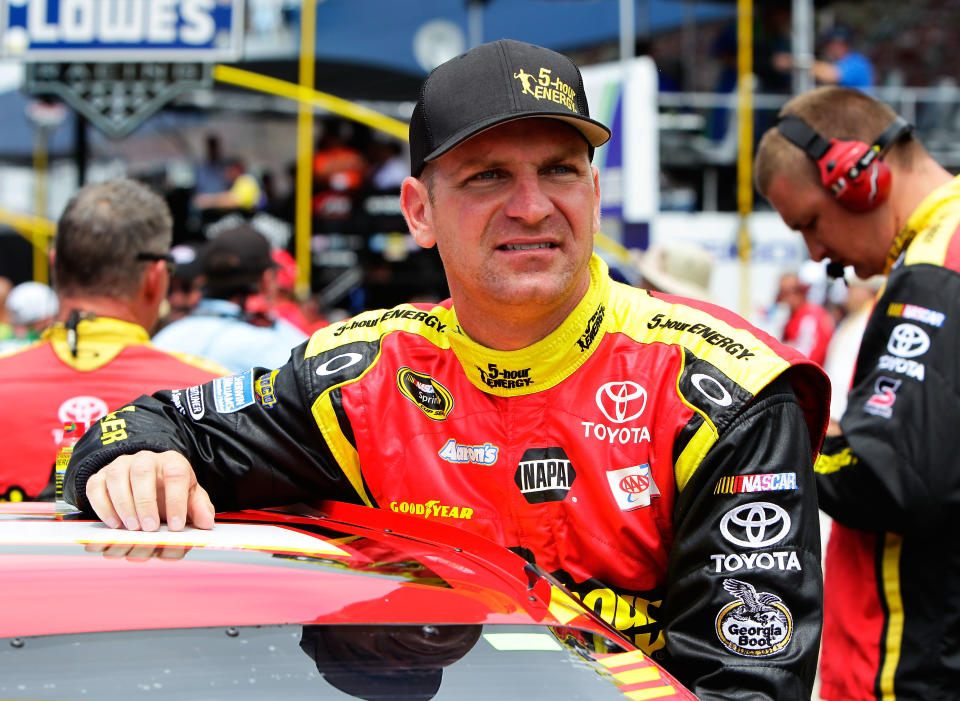 BROOKLYN, MI - JUNE 17: Clint Bowyer, driver of the #15 5-hour Energy Toyota, stands on the grid during pre-race ceremonies for the NASCAR Sprint Cup Series Quicken Loans 400 at Michigan International Speedway on June 17, 2012 in Brooklyn, Michigan. (Photo by Wesley Hitt/Getty Images for NASCAR)