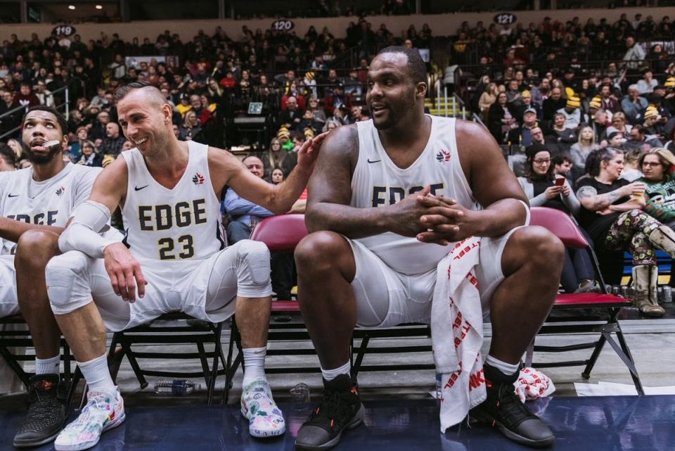 St. John's Edge star and general manager Carl English shares a moment with fan favourite Glen "Big Baby" Davis in front of a crowd at Mile One Centre.