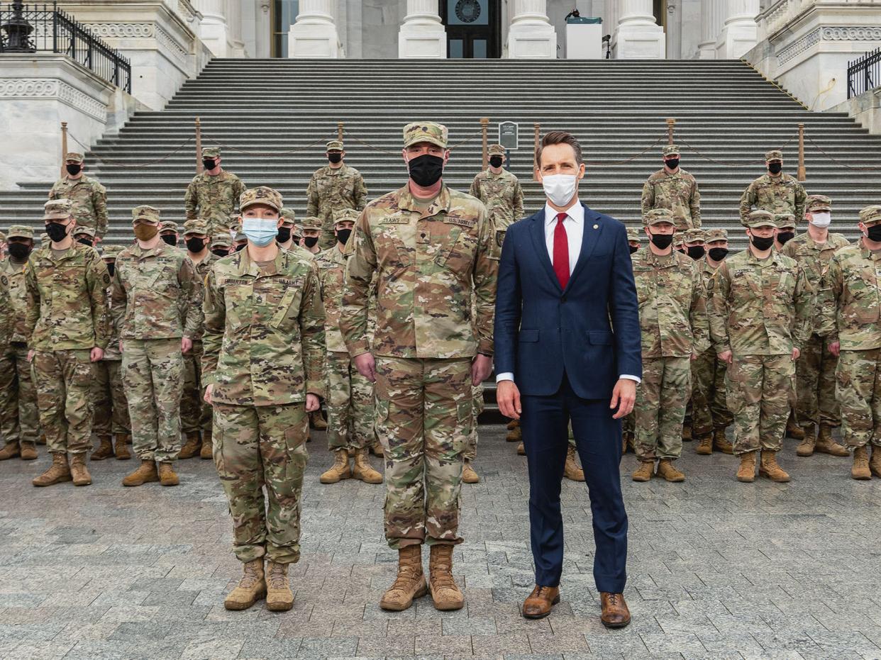 <p>Missouri senator Josh Hawley posing with National Guard troops from his state</p> ((Josh Hawley - Twitter))