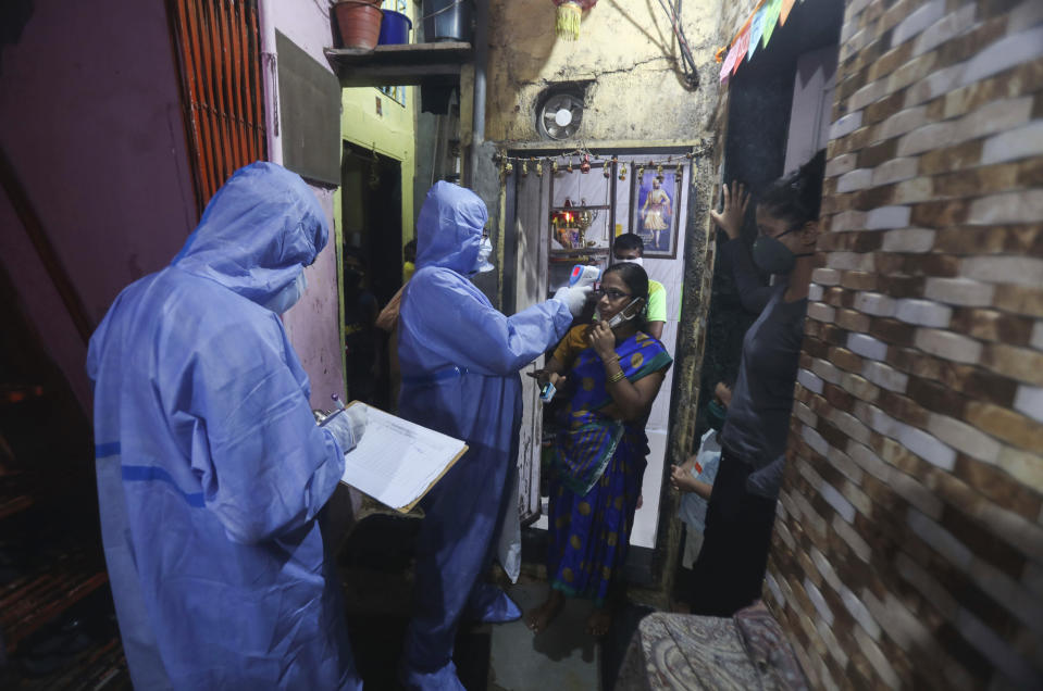 Health workers screen people for COVID-19 symptoms at a slum, in Mumbai, India, Wednesday, July 8, 2020. India has overtaken Russia to become the third worst-affected nation by the coronavirus pandemic. (AP Photo/Rafiq Maqbool)