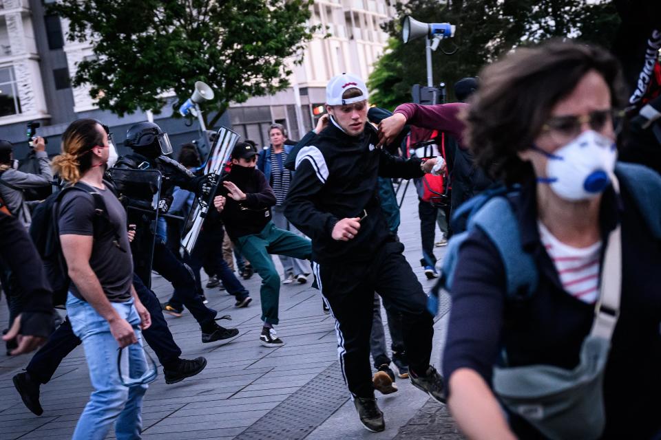 Anti-riot police officers charge protesters during a demonstration in Nantes (LOIC VENANCE/AFP via Getty Images)