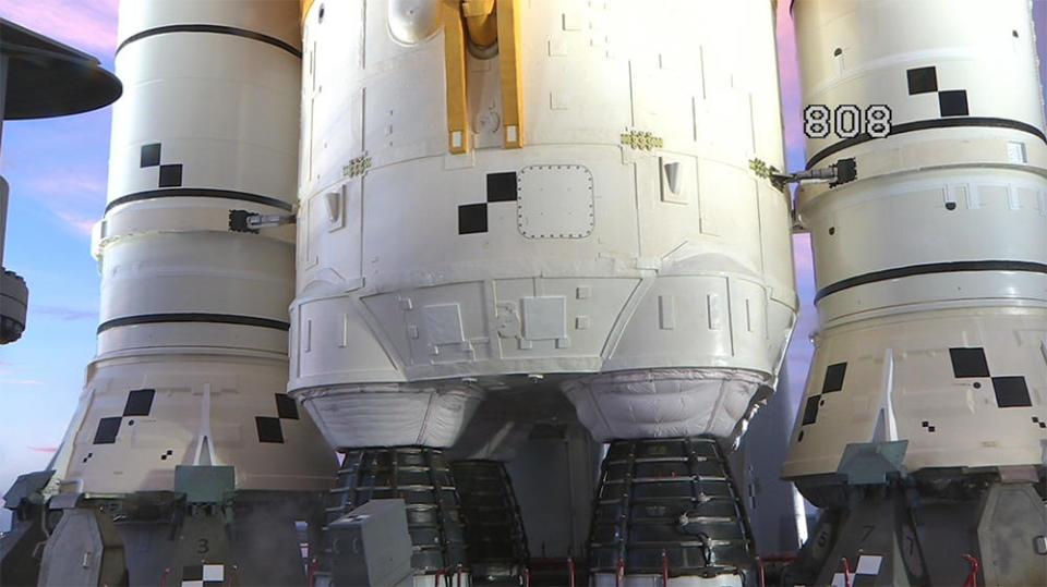 The business end of the SLS moon rocket, with two solid-fuel boosters flanking the core stage and its four hydrogen-fueled RS-25 engines. / Credit: NASA