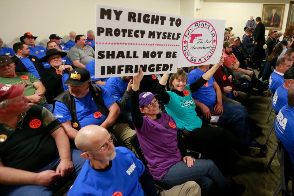 Gun rights protesters rally before a meeting of the Senate Judiciary Committee at the Capitol in Richmond, Va., on Jan. 13. The committee passed several bills that would tighten gun restrictions.