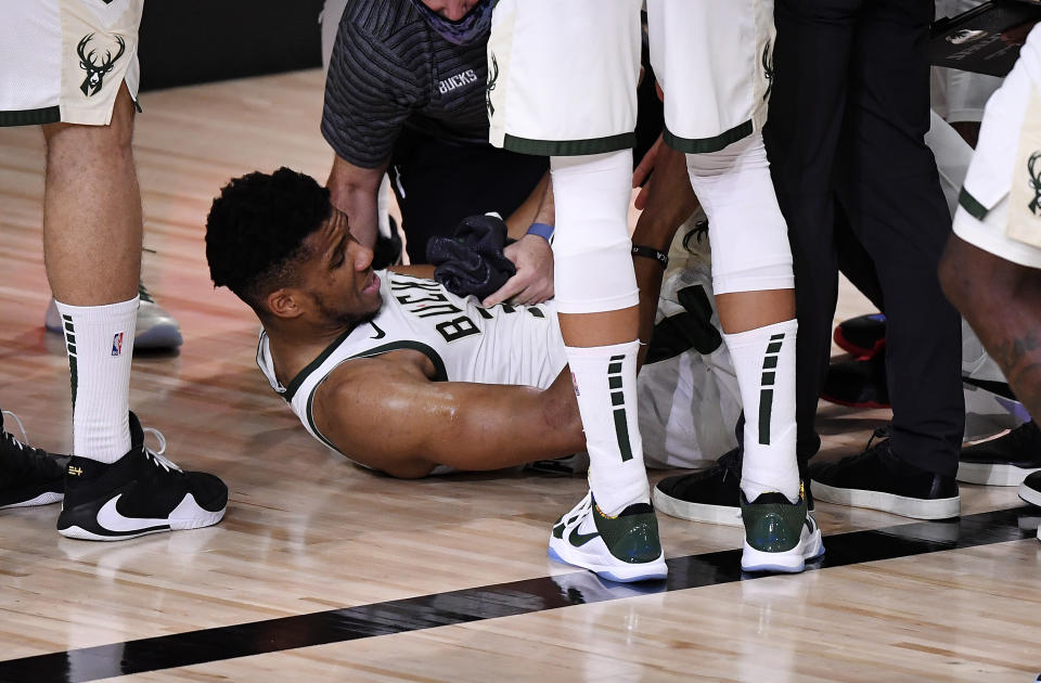 Giannis Antetokounmpo #34 of the Milwaukee Bucks exits the game after an injury during the second quarter against the Miami Heat in Game Four of the Eastern Conference Second Round