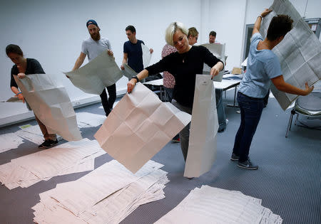 Electoral officials sort ballot papers after the conclusion of voting in the Bavarian state election in Munich, Germany, October 14, 2018. REUTERS/Wolfgang Rattay
