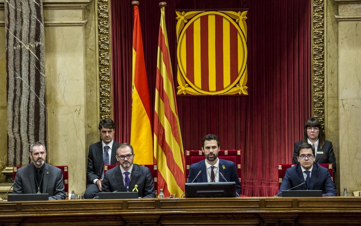 Roger Torrent, new president of the Catalan parliament, center, speaks to lawmakers in the first sitting of the Catalan parliament since direct rule was imposed - Bloomberg