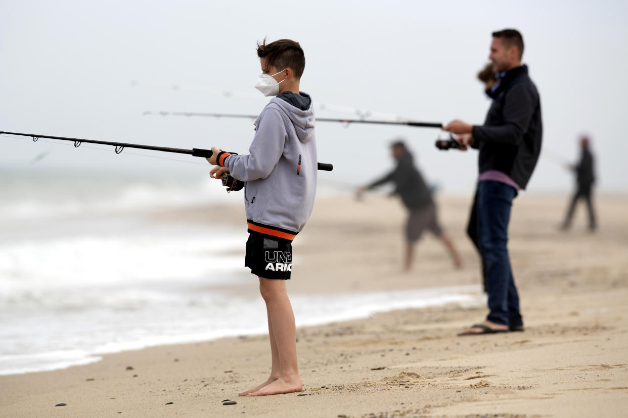 People fishing on the beach