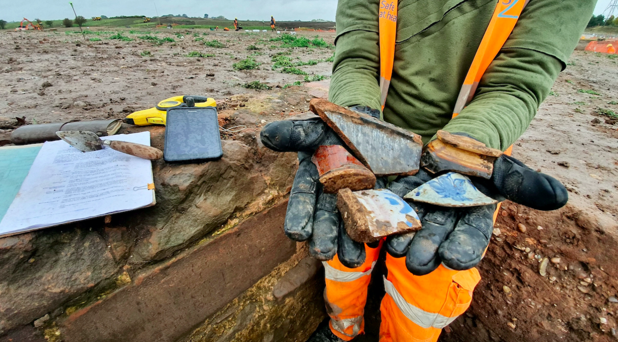 A Wessex archaeologist shows post medieval pottery from the Coleshill Medieval Manor site. (SWNS)