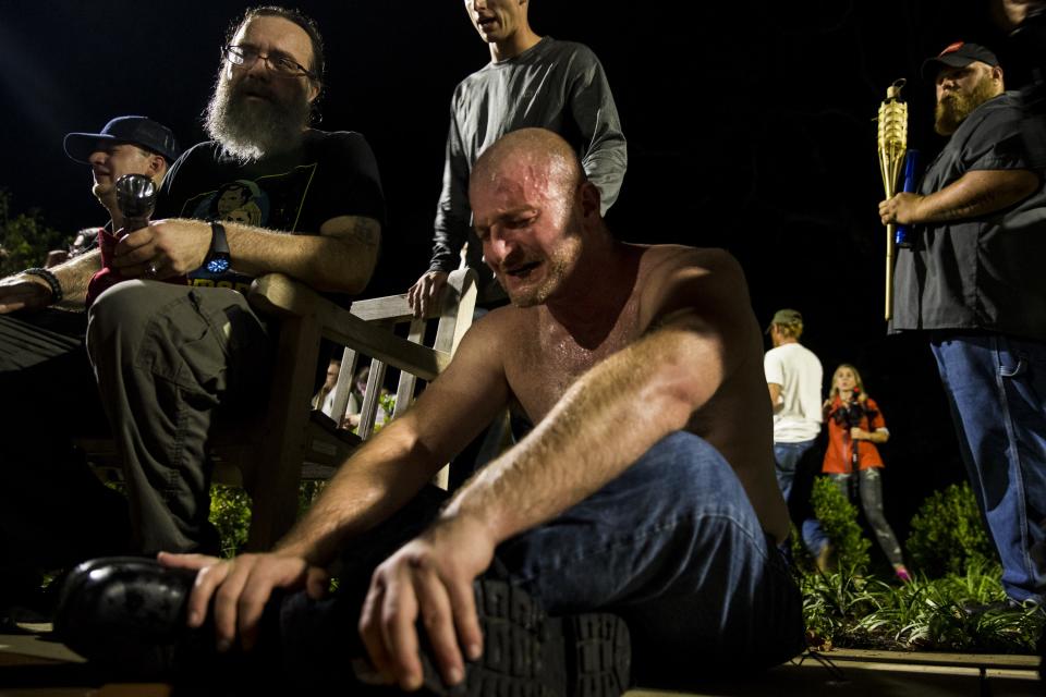 <p>A man cringes after being hit in the face with pepper spray during a clash between counter protestors and Neo Nazis, Alt-Right, and White Supremacist groups after they marched through the University of Virginia Campus with torches in Charlottesville, Va., on Aug. 11, 2017. (Photo: Samuel Corum/Anadolu Agency/Getty Images) </p>