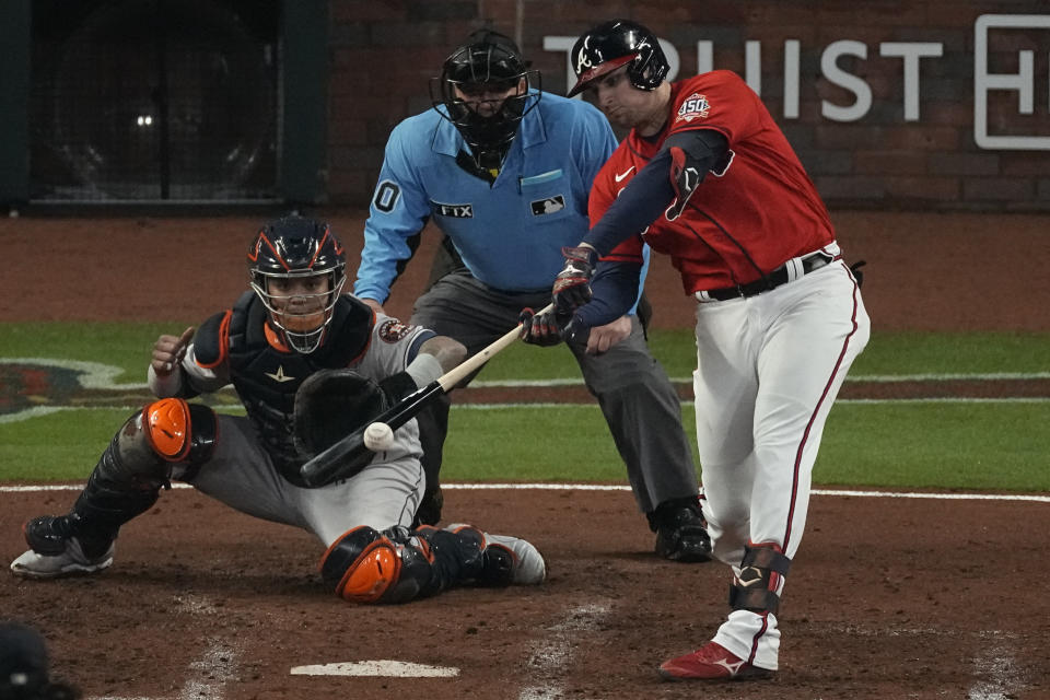 Atlanta Braves' Austin Riley hits a RBI-double during the third inning in Game 3 of baseball's World Series between the Houston Astros and the Atlanta Braves Friday, Oct. 29, 2021, in Atlanta. (AP Photo/John Bazemore)