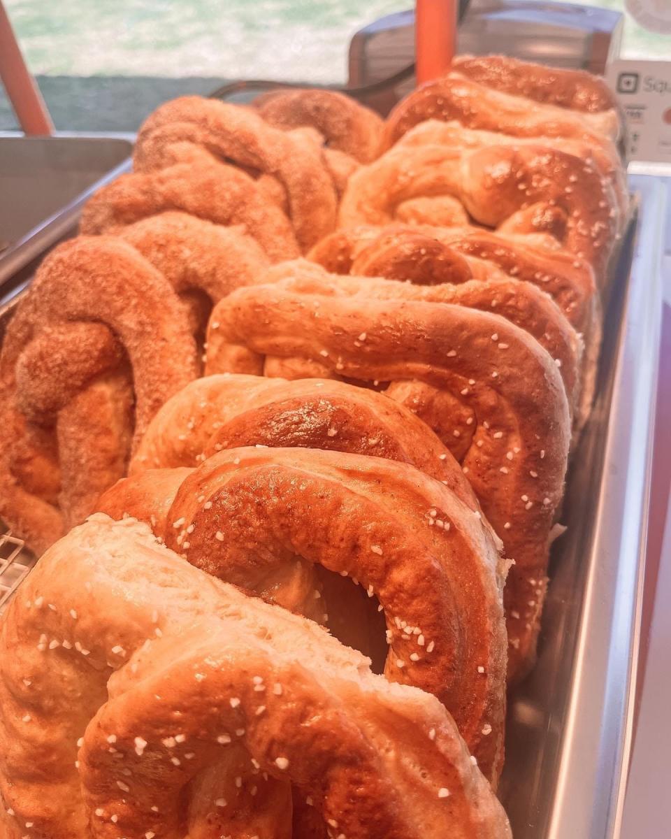 There are two varieties of Katie’s Soft Pretzels: salted and served with cheddar cheese sauce or sweet mustard, and cinnamon pretzels served with a white icing dip.