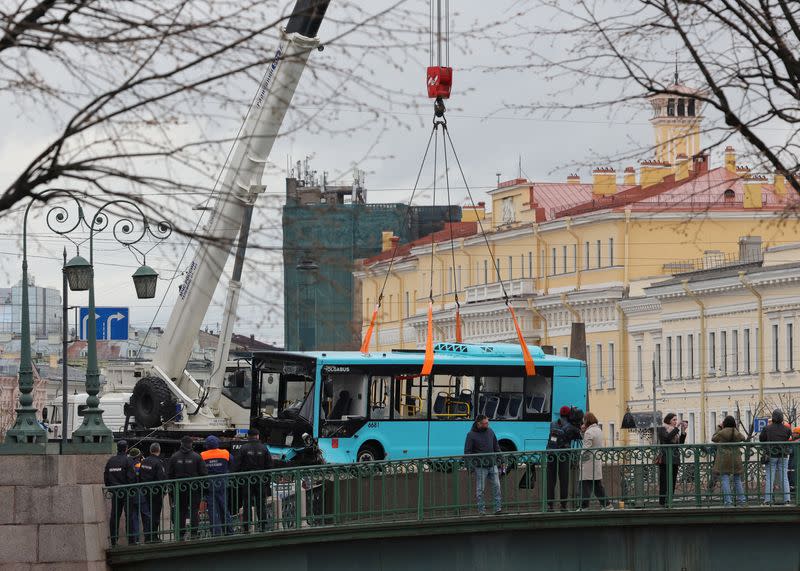 Rescuers work at the site where a bus fell into a river in Saint Petersburg