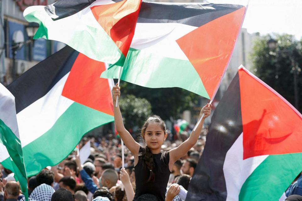 PHOTO: A girl holds Palestinian flags as Palestinians take part in a protest in support of the people in Gaza in Ramallah in the Israeli-occupied West Bank Oct. 18,2023. (Mohamad Torokman/Reuters)