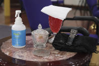 Items are laid out for mourners, including hand sanitizer, before the funeral service for Bishop Carl Williams, Jr. in the Brooklyn borough of New York, Thursday, May 21, 2020. Carl Williams, Jr. was the emeritus pastor of the Institutional International Ministries, a congregation started by his father Carl Williams, Sr. The congregation and Williams Jr. are more widely known for their gospel group, the Institutional Radio Choir. Williams Jr. was a featured singer singer in, directed and managed the choir for over 30 years and took a star turn on Broadway when he was cast in the musical "The Gospel at Colonus". (AP Photo/Seth Wenig)