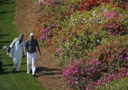 Denmark's Thomas Bjorn and his caddie (L) walk down the sixth fairway during the second round of the Masters golf tournament at the Augusta National Golf Club in Augusta, Georgia April 11, 2014. REUTERS/Mike Blake (UNITED STATES - Tags: SPORT GOLF)