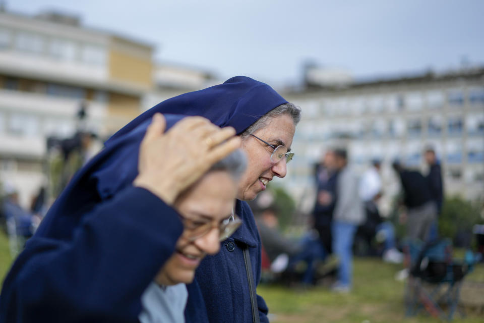 Nuns walk walk past the Agostino Gemelli hospital in front of the rooms on the top floor normally used when a pope is hospitalised, in Rome, Thursday, March 30, 2023, after The Vatican said Pope Francis has been taken there in the afternoon for some scheduled tests. The Vatican provided no details, including how long the 86-year-old pope would remain at Gemelli University Hospital, where he underwent surgery in 2021. But his audiences through Friday were canceled, raising questions about Francis' participation during the Vatican's Holy Week activities starting Sunday. (AP Photo/Andrew Medichini)