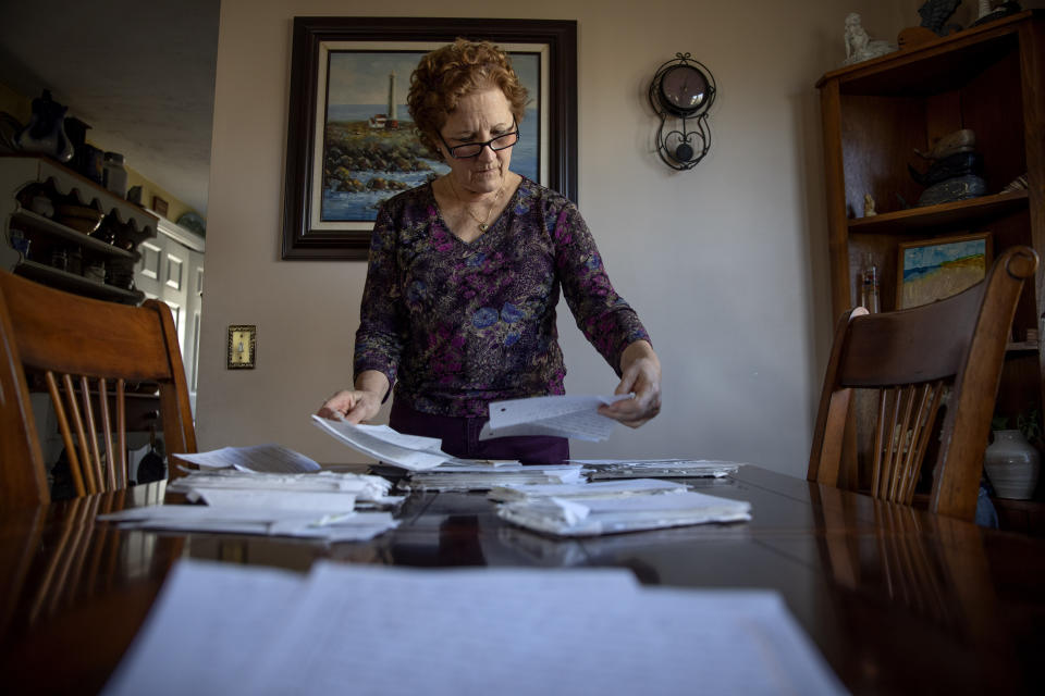 Janet Uhlar goes through letters she received through her correspondence with imprisoned Boston organized crime boss James "Whitey" Bulger, Friday, Jan. 31, 2020, in Eastham, Mass. During her correspondence and visits with Bulger, Uhlar said, she grew fond of the gangster, though he often warned her that he was a criminal and "master manipulator." When asked if Bulger might have manipulated her, she said, "I've asked myself that many times. I'll finish reading a letter and say, 'Could he have?' "(AP Photo/David Goldman)