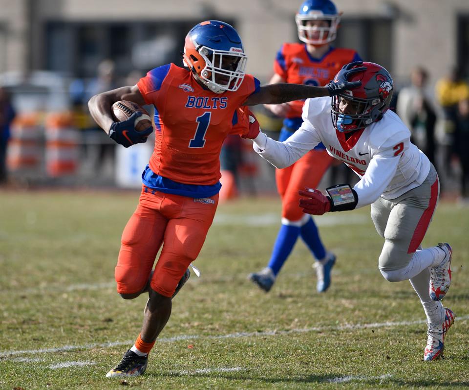 Millville's LeQuint Allen (1) runs for a gain against Vineland. The Thunderbolts topped the Fighting Clan 47-0 at Wheaton Field on Thursday, Nov. 25, 2021.