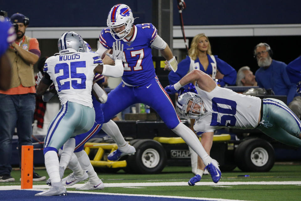 Dallas Cowboys safety Xavier Woods (25) and linebacker Sean Lee (50) defend as Buffalo Bills quarterback Josh Allen (17) reaches the end zone for a touchdown in the second half of an NFL football game in Arlington, Texas, Thursday, Nov. 28, 2019. (AP Photo/Michael Ainsworth)