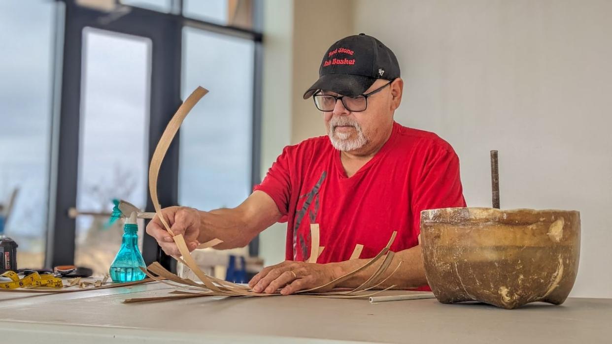 Mi'kmaw elder Francis Jadis is weaving handmade baskets every Friday as the latest climate artist-in-resident at the Canadian Centre for Climate Change and Adaptation in St. Peter’s Bay, P.E.I.   (Shane Hennessey/CBC  - image credit)