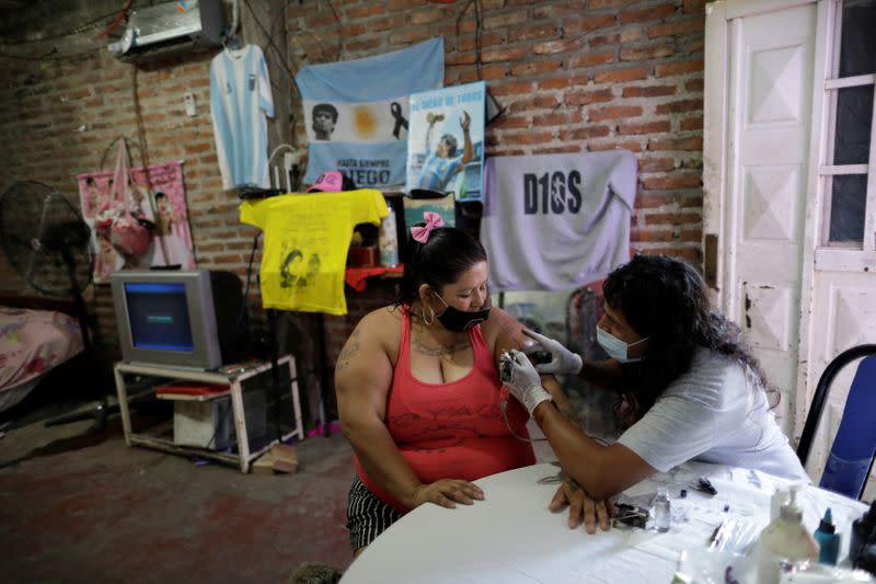 The Wider Image: Argentines celebrate 'eternal love' for Maradona with tattoos